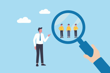 Business man examining potential employees through a magnifying glass for recruitment and hiring purposes