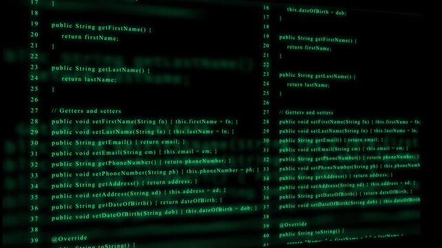 Dual screen display of programming code in green on a dark background for software development Keywords: code, programming, software, development, java, class, object oriented, programming
