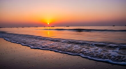 A tranquil sunrise paints the coastal scene with vibrant hues, as gentle waves kiss the sandy shore, a calm morning by the ocean.