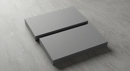 Two stacks of blank gray rectangular cards on a textured light gray surface, ideal for mockups.