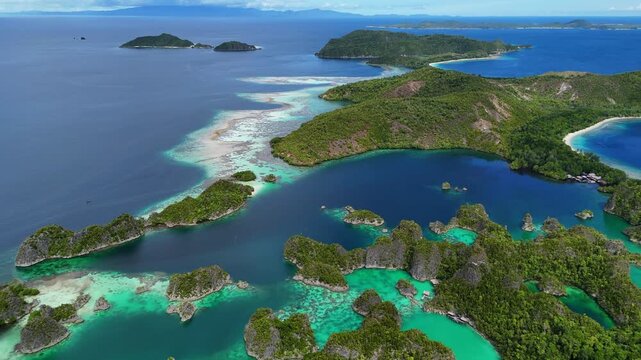 Aerial view of Piaynemo islands in Raja Ampat, Indonesia, with turquoise lagoons, lush green karst islets and stunning tropical seascape, symbol of exotic travel and adventure