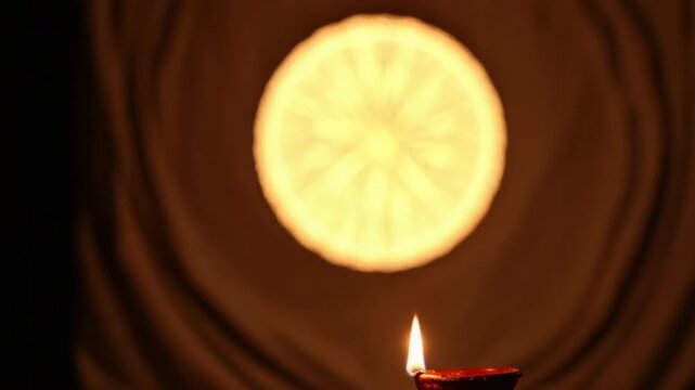Fireworks explosion bokeh effect on black background and burning oil lamp on wall during Diwali festival celebration. Diwali Background.