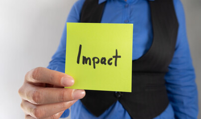 Businesswoman showing a sticky note with the word 
