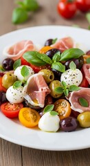 A colorful and appetizing salad featuring fresh mozzarella balls, colorful cherry tomatoes, olives, and prosciutto.