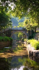 A serene stone arch bridge spans a calm, tree-lined canal in a lush green park setting.