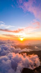 Majestic sunset over a mountain range shrouded in clouds