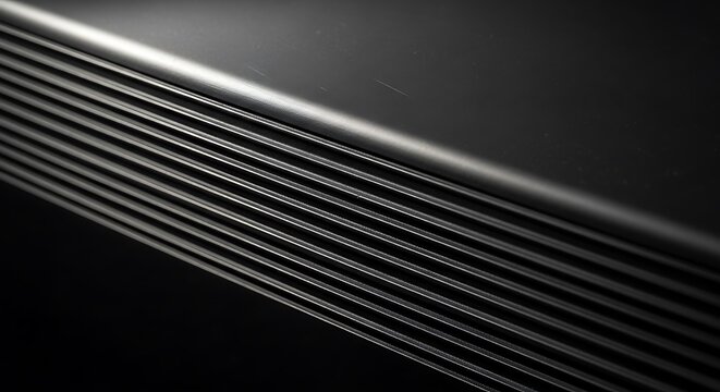 Close-up view of a dark, textured surface with parallel lines, showcasing a sleek and modern design.