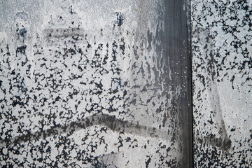Water droplets form unique patterns on metal, showcasing nature's art in the city