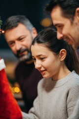 Fototapeta premium A heartwarming depiction of a family sharing the magic of Christmas, gathering together to decorate.
