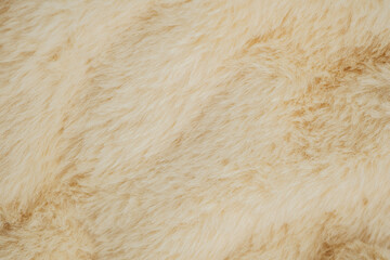 Soft beige fur texture for cozy winter fashion or interior design concepts