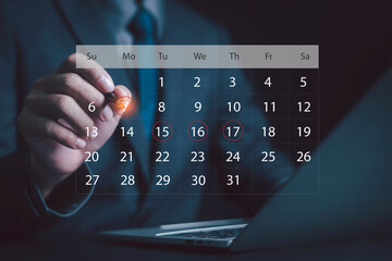 Obraz premium Businessman pointing at digital calendar on virtual screen, symbolizing time management, schedule planning, business organization, meeting reminder, productivity, and corporate efficiency.