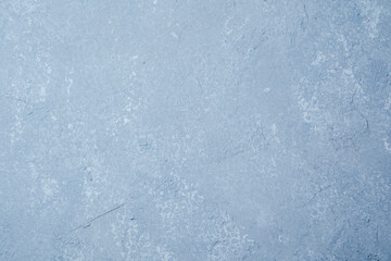 Light blue wall with smooth grunge plaster and faded surface texture