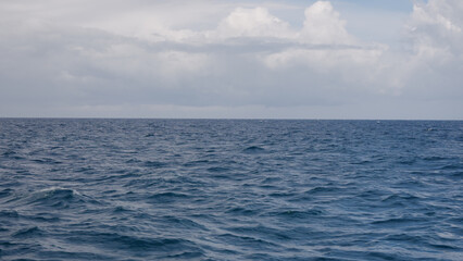 Fototapeta premium Side view from boat in Indian ocean sailing between Seychelles islands in daytime
