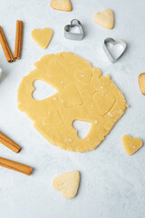 Heart shaped cookie dough cutting with cinnamon and eggs for baking, valentines or romantic concept