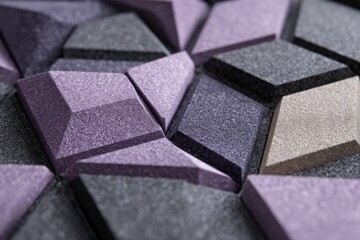 Close-up of sound-absorbing foam tiles arranged symmetrically, charcoal and pale lavender, acoustic material study 