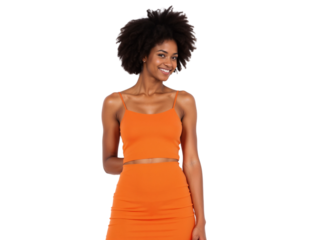 Smiling woman in orange outfit poses confidently in studio setting during daytime