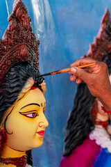 Artisan Painting a Durga Idol A Glimpse into Hindu Religious Art. Durga Puja celebrations in Bangladesh, a vibrant display of faith and culture.
