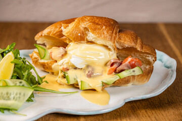 Croissant sandwich with poached egg and hollandaise