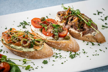 Assorted gourmet bruschetta with salmon, tomato and beef