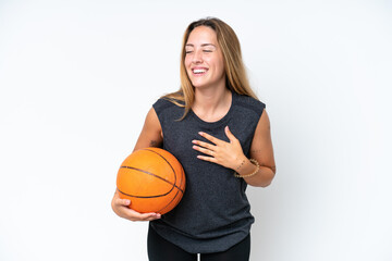 Obraz premium Young basketball caucasian player woman isolated on white background smiling a lot