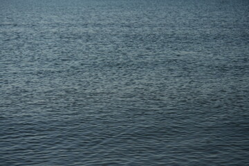 Surface of the Black Sea with natural ripples and soft blue-gray tones. The calm water texture is ideal for use as a background, design element, or for illustrating ocean, sea, or nature concepts