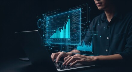 A data analyst or software developer is working on a laptop in a dark, high-tech environment. A large, complex holographic interface with glowing blue data visualizations, including bar charts, graphs
