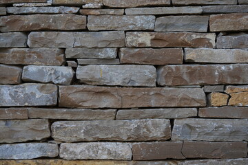 Stone wall texture background – natural masonry made of stacked rocks and bricks, rustic construction material surface, architectural stonework pattern for design, building and decorative concepts