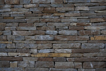 Stone wall texture background – natural masonry made of stacked rocks and bricks, rustic construction material surface, architectural stonework pattern for design, building and decorative concepts