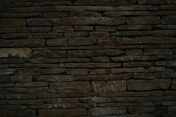 Obraz premium Old stone wall texture background Dark brown brick stone masonry close up Rustic stone wall pattern for design