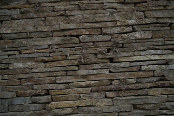 Stone wall texture old masonry background dark stone bricks close up texture Rustic stone wall natural background