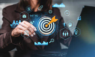 Businesswoman setting target with digital strategy icons on holo