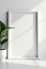 Blank minimalist white frame against stark white wall, modern, art gallery, texture