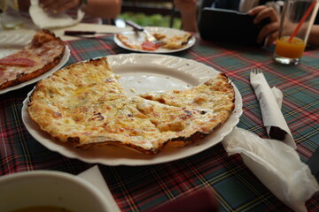 Four cheese pizza close up – traditional Italian Quattro Formaggi with melted mozzarella, gorgonzola, parmesan and ricotta on plate, delicious baked fast food meal for restaurant, delivery and cooking