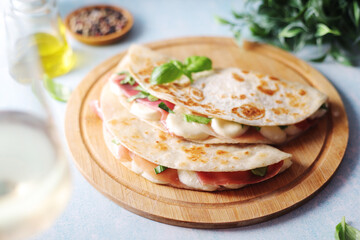 	
Traditional Italian dish Piadina romagnola - flat bread with mozarella and proscuitto