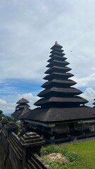 Roofs of ancient Indonesian temples viewed from above against the sky.