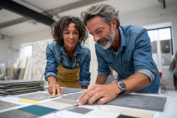 Couple selecting flooring samples in renovation store, teamwork moment,