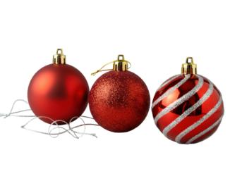 Three distinct red Christmas ornaments (matte, glitter, glossy with silver stripes, gold caps) and silver threads on transparent, concept of festive elegance.