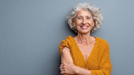 smiling healthy mature older senior happy woman showing bandage on arm after getting vaccination vaccine and old elder people inoculation elderly immunity for covid prevention concept portrait no log