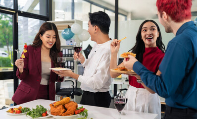 business team are excited business success with inspiration from their excellent financial results, celebration successful deal with champagne and pizza in the workplace.