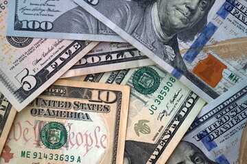 Big amount of different dollar bills close up. Hundred fifty twenty ten and five dollar banknotes