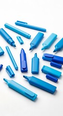 A collection of assorted, vibrant shades of blue markers arranged in a visually appealing design on a plain white background.