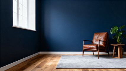 Minimalist room with navy blue walls, leather armchair, wooden floor, and potted plant near a window
