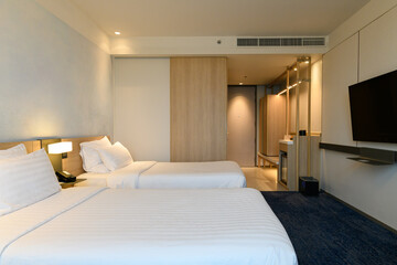 A double bed covered with white sheds in a beautiful bedroom.