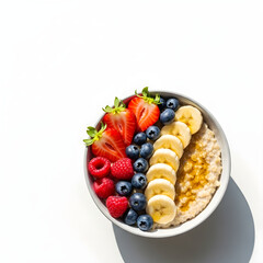 Nutritious oatmeal bowl topped with fresh berries and sliced bananas, a healthy breakfast.