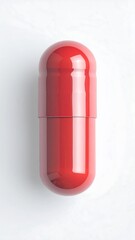 Red pill on a white surface