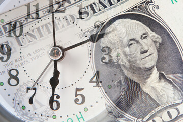 Fototapeta premium Close up of clock face and dollar banknote. Time is money concept.