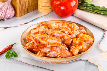 Raw marinated uncooked chicken wings