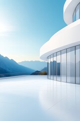 Modern white curved building with glass walls overlooking mountainous landscape under clear blue sky