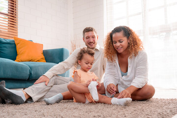 Family. Happy family with little daughte having fun at home. Smiling young parents and their child are very happy. Parenthood and people concept.	