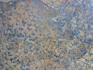 Abstract random oxidized metal plate splashed and sprayed with acid. Beautiful weathered and rusty metal texture in different shades of color, acid etched metal. Seamless background texture.